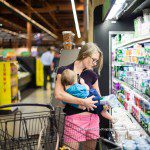 Mom breastfeeding while choosing yogurt at local grocery store, Wegmans. Finding the right Northern Virginia Lactation Consultant for your journey—explore top IBCLCs, their services, and how they can support you.