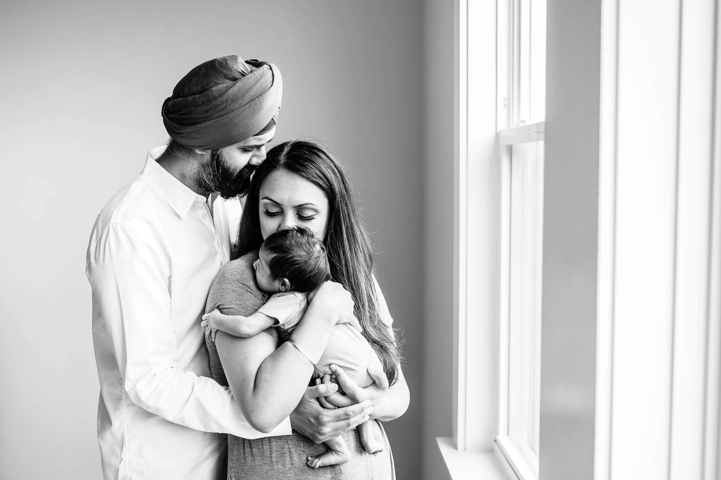 Northern Virgina newborn photo of Sikh parents with baby in black and white.