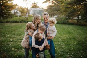Family of 6 hugging at sunset by Northern VA family photographer