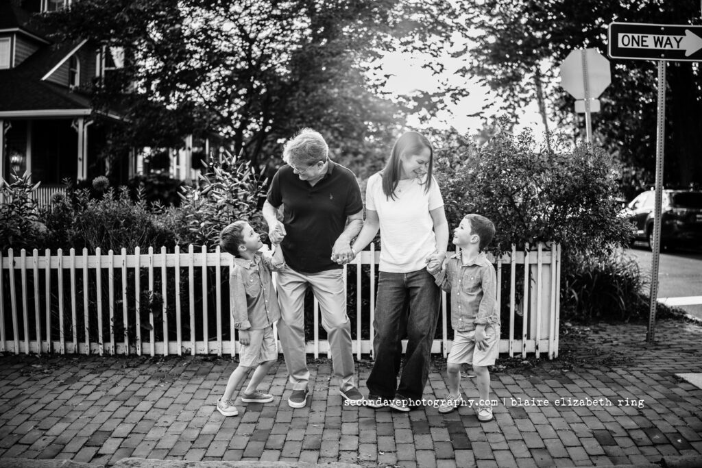 Black and white photo of LGBTQIA+ family of 4 laughing in Leesburg VA.