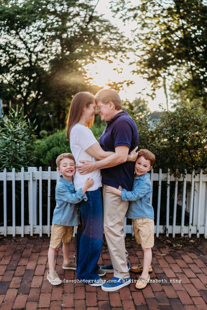 LGBTQIA+ family of 4 hugging and laughing in Leesburg VA.