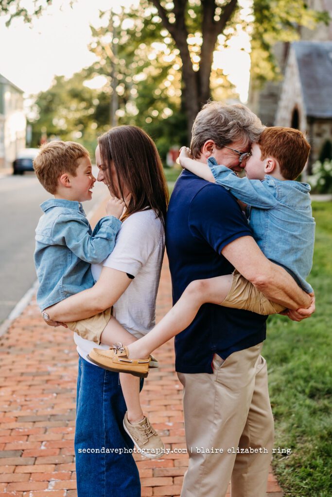 LGBTQIA+ family of 4 hugging and laughing in Leesburg VA.
