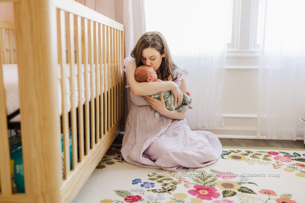 Mom kissing new baby on the head at newborn session in Reston VA.