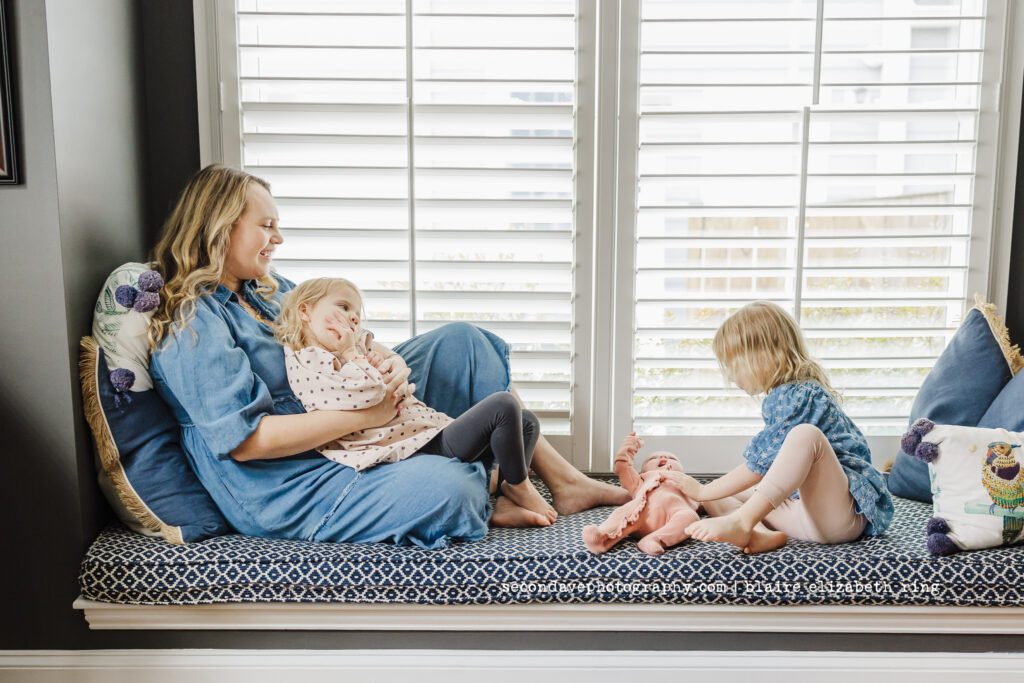 Lifestyle newborn photo with toddler twins.