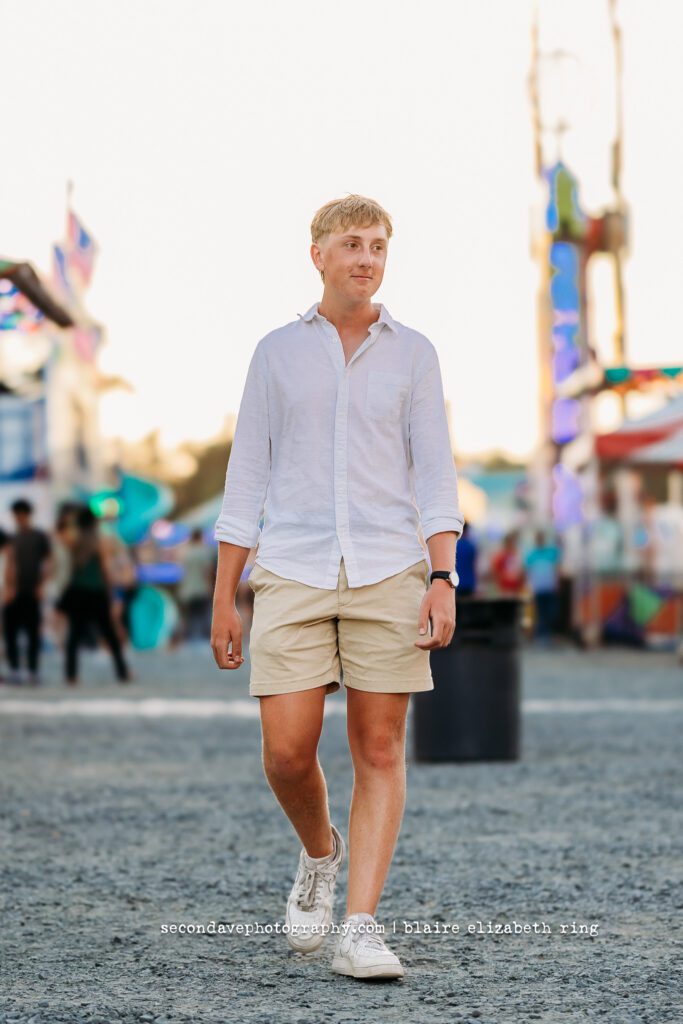 Senior photographer photographs high school senior at One Loudoun Carnival in Ashburn, Virginia.
