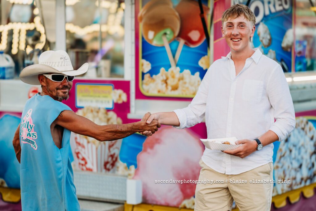 Senior photographer photographs high school senior at One Loudoun Carnival in Ashburn, Virginia.