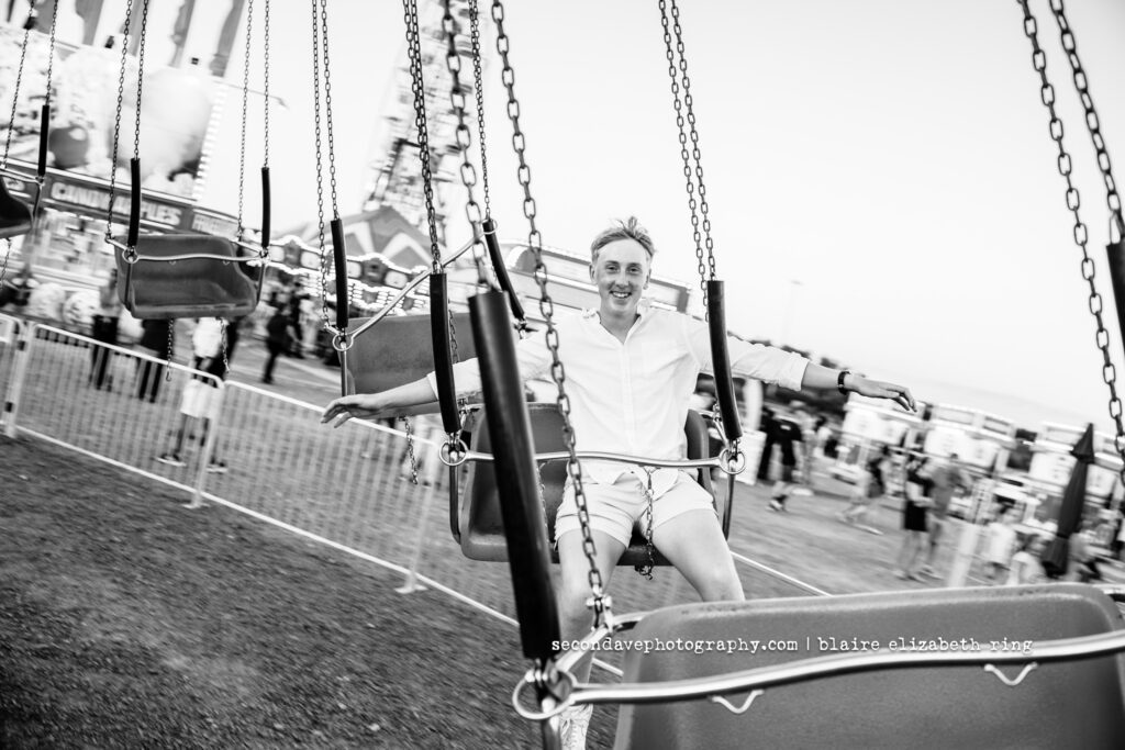 Senior photographer photographs high school senior at One Loudoun Carnival in Ashburn, Virginia.
