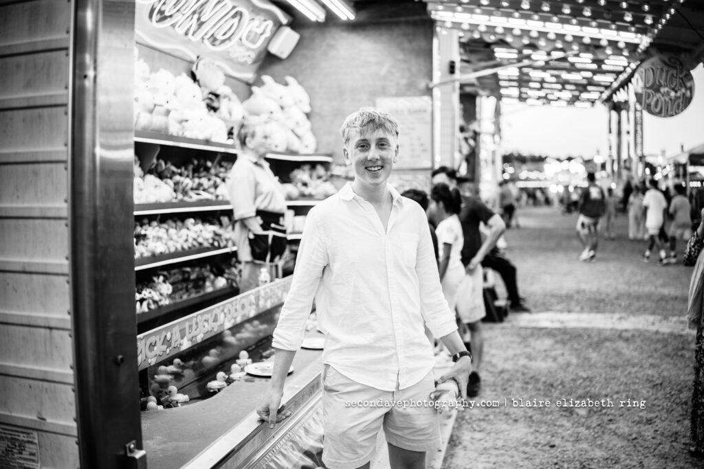 Senior photographer photographs high school senior at One Loudoun Carnival in Ashburn, Virginia.