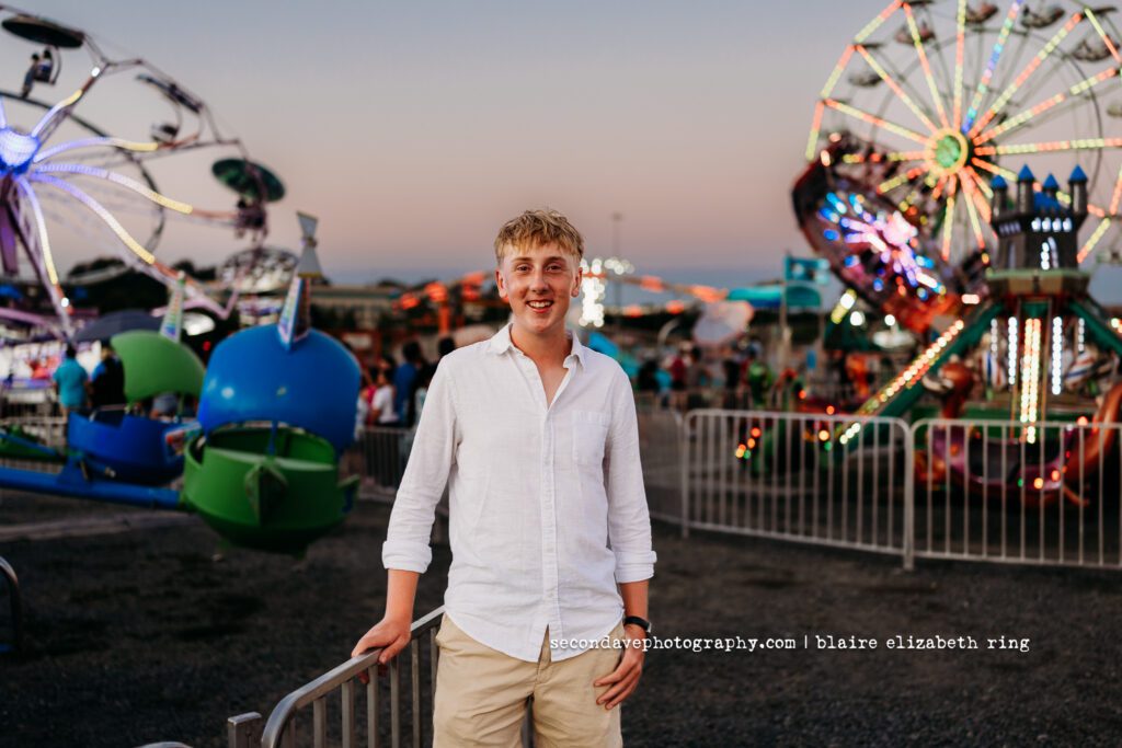 Senior photographer photographs high school senior at One Loudoun Carnival in Ashburn, Virginia.