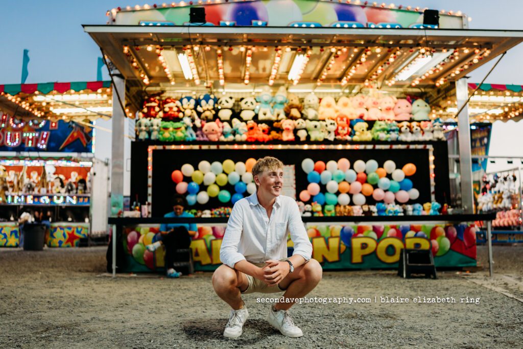 Senior photographer photographs high school senior at One Loudoun Carnival in Ashburn, Virginia.